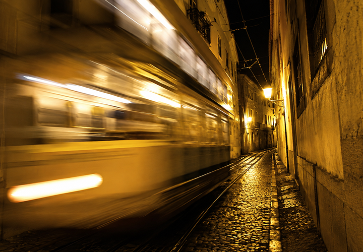 Blurred Lisbon tram at night
